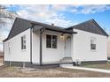 Charming home featuring a neutral color scheme and a well-maintained front yard at 2 S Knox Ct, Denver, CO 80219