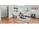 Bright living room with hardwood floors, stylish decor, and ample natural light at 2 S Knox Ct, Denver, CO 80219