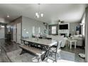 Open-concept dining area featuring a large table with bench seating and stylish decor at 975 Alta St, Lochbuie, CO 80603