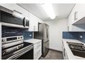 Modern kitchen with stainless steel appliances, quartz countertops, and blue backsplash at 4600 E Asbury Cir # 210, Denver, CO 80222