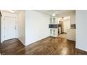 Open living room and kitchen featuring hardwood floors and white cabinets at 4600 E Asbury Cir # 210, Denver, CO 80222