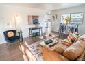 Bright living room with hardwood floors, modern furnishings, and natural light; seamlessly blends style and comfort at 6190 Ivy St, Commerce City, CO 80022