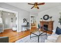 Spacious living room with hardwood floors, a decorative fireplace, and open access to the dining area for seamless entertaining at 1239 N Lafayette St, Denver, CO 80218