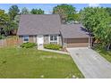 Aerial view of a charming home with a well-manicured lawn and attached garage at 6579 Ingalls St, Arvada, CO 80003