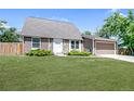 Attractive single-Gathering home with stone accents, green lawn, and an attached garage at 6579 Ingalls St, Arvada, CO 80003
