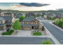 Expansive aerial view of a charming neighborhood showcasing well-maintained homes and scenic surroundings at 7310 Blue Water Dr, Castle Rock, CO 80108