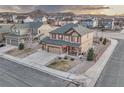 Beautiful aerial view of a two-story home showcasing its landscaped yard and neighborhood with mountain views at 7310 Blue Water Dr, Castle Rock, CO 80108