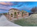 Well-maintained backyard featuring a wooden fence, gravel landscaping, and exterior views of the home at 7310 Blue Water Dr, Castle Rock, CO 80108