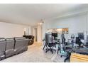 Open floor plan living room leads to a connected kitchen and office space at 12504 E Cornell Ave # 103, Aurora, CO 80014