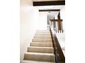 Bright staircase featuring carpeted steps, wooden beams and a skylight above at 2090 S Hannibal Way # C, Aurora, CO 80013