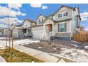 Two-story house on a tree-lined street with a gravel driveway at 13352 E 110Th Way, Commerce City, CO 80022