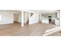 Open living room with hardwood floors and an open kitchen at 13352 E 110Th Way, Commerce City, CO 80022