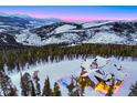 Aerial view of luxury cabin, pool, and mountain landscape with evergreen trees at 250 Sallie Barber Rd, Breckenridge, CO 80424