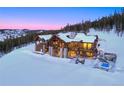 Luxury mountain home with timber frame, stone pillars, and outdoor living space at 250 Sallie Barber Rd, Breckenridge, CO 80424