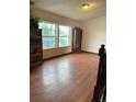 Bright living room boasts hardwood floors, large windows, and ample space for relaxation and entertaining at 47904 Dartmouth Ave, Bennett, CO 80102