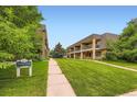 Well-maintained townhouse complex with manicured lawns and mature trees at 6727 S Race St, Centennial, CO 80122