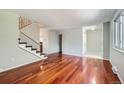Bright living room featuring hardwood floors and staircase with modern design at 6727 S Race St, Centennial, CO 80122