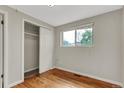 Bright bedroom features hardwood floors, large window, and closet with sliding doors at 8881 Judson St, Westminster, CO 80031