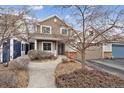 Beautiful home exterior showcasing the walkway, front garden, and attached garage on a sunny day at 9118 W 50Th Ln # 5, Arvada, CO 80002