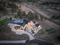 Expansive aerial view showcases the home's backyard pool, landscaping, patio, and surrounding natural beauty of the lot at 13176 Frannys Way, Parker, CO 80138