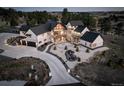 Gorgeous home featuring an oversized driveway, pristine landscaping, patio with fireplace, and outdoor living spaces at 13176 Frannys Way, Parker, CO 80138