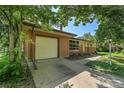 A brick and siding home featuring a concrete driveway and an attached single-car garage at 426 Kenton St, Aurora, CO 80010