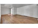 A well lit living room featuring gray walls and beautiful hardwood floors at 426 Kenton St, Aurora, CO 80010