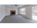 Living room features fresh paint, a fireplace, new carpet, and sliding door to backyard at 10799 Murray Dr, Northglenn, CO 80233