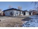 Updated duplex features a sleek design and a partially snow-covered yard at 3430 N Cook St, Denver, CO 80205