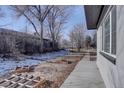 Side yard with a concrete pathway and raised garden beds at 3430 N Cook St, Denver, CO 80205