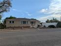 Charming single story home with brick accents and manicured front yard landscaping at 1009 Bush St, Brighton, CO 80601