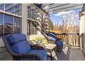 Cozy front porch featuring wicker chairs with blue cushions, perfect for relaxation at 14023 W Amherst Pl, Lakewood, CO 80228