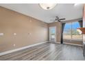 Bright living room with modern flooring, a ceiling fan, and a door leading to a balcony at 9039 E Panorama Cir # C204, Englewood, CO 80112