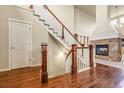 Inviting entryway with hardwood floors, a staircase, and a stone fireplace in the living area at 2344 S Lupine St, Denver, CO 80228