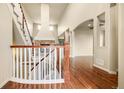 Spacious entryway featuring hardwood floors, staircase, and view of the living room fireplace at 2344 S Lupine St, Denver, CO 80228
