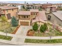 Charming two-story home featuring a stone facade, covered balcony, and well-manicured landscaping in a desirable neighborhood at 2344 S Lupine St, Denver, CO 80228