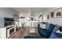 Cozy living room featuring hardwood floors, blue sofa, and dining area at 800 N Washington St # 804, Denver, CO 80203