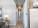 Long hallway featuring gray walls, lighting and wood floors, with doorways visible in the distance at 1300 Golden Cir # 304, Golden, CO 80401
