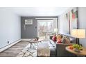 Comfortable living room with a couch, soft rug, and a sliding glass door to the outside at 1300 Golden Cir # 304, Golden, CO 80401
