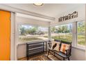 Bright sunroom featuring large windows with views, hardwood floors, and mountain decor at 1271 Uinta St, Denver, CO 80220