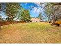Expansive backyard featuring a lush lawn, mature trees, and privacy fence at 18022 E Loyola Pl, Aurora, CO 80013