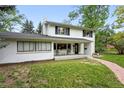 Attractive two-story home with a bright white exterior, well-maintained lawn, and a charming front porch at 11880 W 30Th Pl, Lakewood, CO 80215