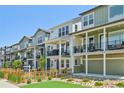 Street view of modern homes with balconies, offering a stylish and comfortable living experience at 14952 Gladshine Dr, Parker, CO 80134