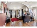 Bright living room with hardwood floors, a fireplace, and access to the bar area at 8559 W 93Rd W Ct, Broomfield, CO 80021