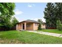 Single story home with a covered entrance and a spacious front yard at 10505 Lowry Pl, Aurora, CO 80010