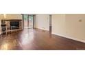 Spacious living area with brick fireplace, hardwood floors, and bright natural light at 2223 S Buckley Rd # 102, Aurora, CO 80013