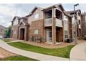 Charming exterior featuring stone accents, private balconies, and well-maintained landscaping at 7440 S Blackhawk St # 9-108, Englewood, CO 80112