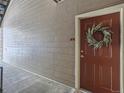 Condo front door with wreath hanging on the door and wood-look siding providing a welcoming entrance at 7440 S Blackhawk St # 9-108, Englewood, CO 80112
