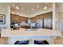 Well-lit kitchen with a breakfast bar, stainless steel appliances, and modern cabinetry at 903 W 129Th Pl, Westminster, CO 80234