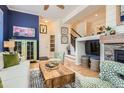 Open-concept living room featuring a stone fireplace and seamless flow into other living areas at 9486 Elmhurst Ln # D, Highlands Ranch, CO 80129